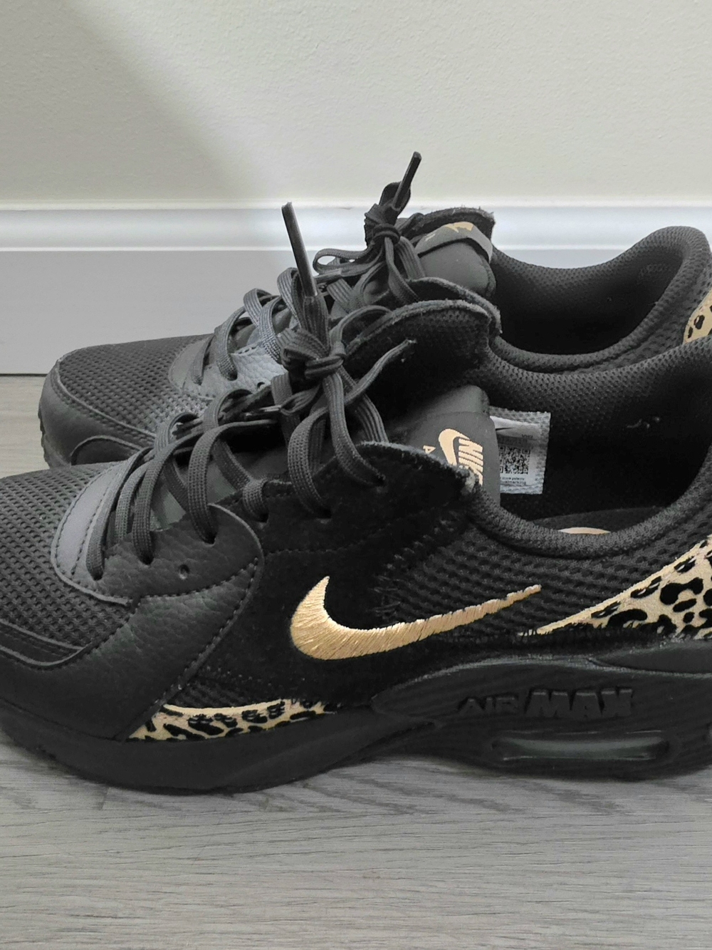 Nike Women's Black Sneakers with Gold Swoosh and Leopard Accent